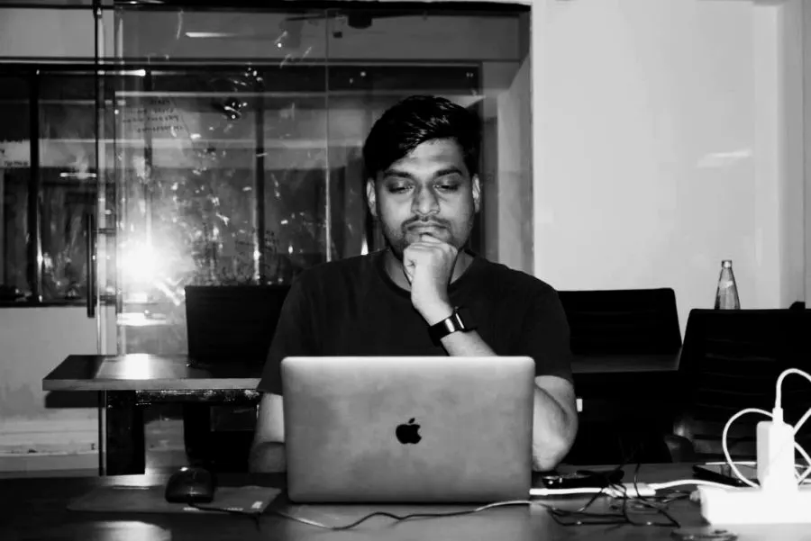 Tushar working at a laptop, black and white
